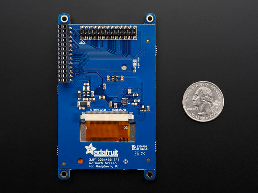 Top down view of a white hand touching the display of a PiTFT - Assembled 480x320 3.5" TFT+Touchscreen for Raspberry Pi.