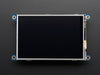 Top down view of a white hand touching the display of a PiTFT - Assembled 480x320 3.5" TFT+Touchscreen for Raspberry Pi.