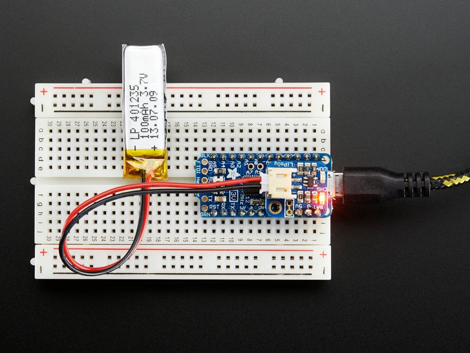 Adafruit LiIon/LiPoly Backpack soldered onto a Pro Trinket, plugged into a solderless breadboard.