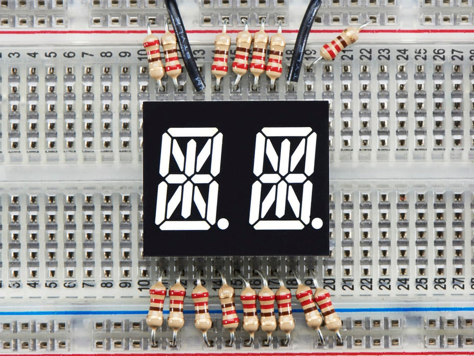 White Dual Alphanumeric Display module wired to breadboard, all segments lit