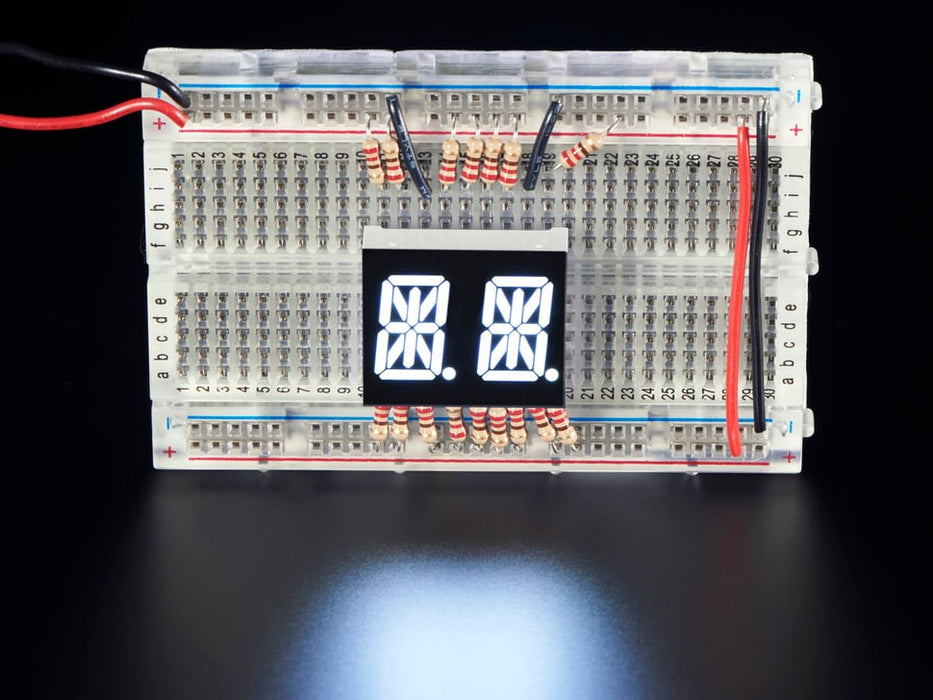 White Dual Alphanumeric Display module wired to breadboard, all segments lit