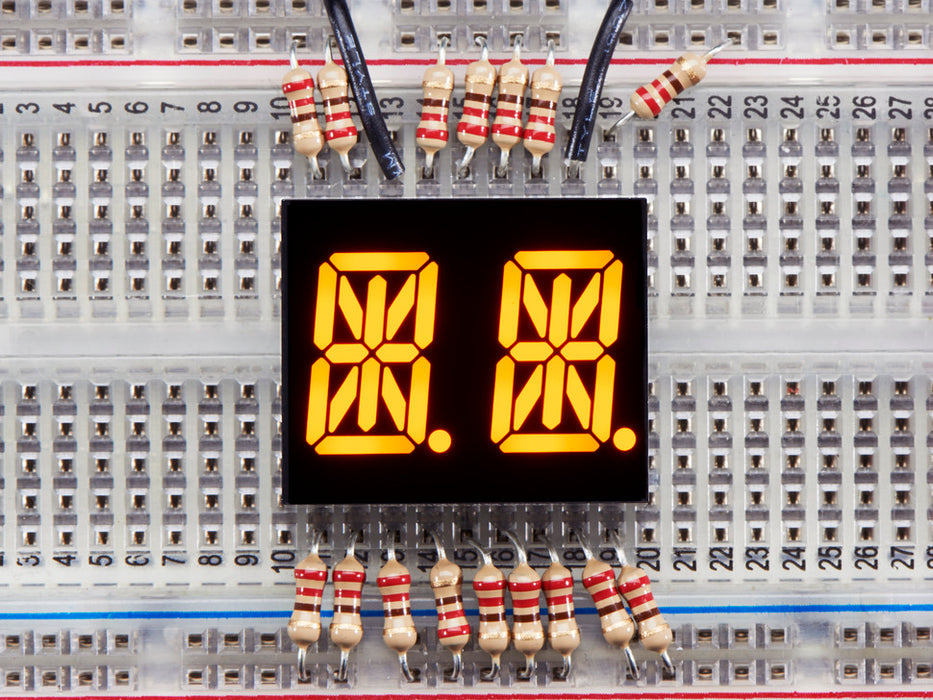 Yellow Dual Alphanumeric Display module wired to breadboard, all segments lit