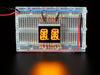 Yellow Dual Alphanumeric Display module wired to breadboard, all segments lit