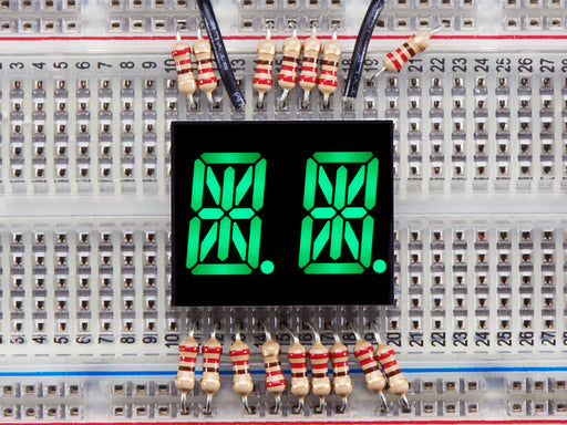 green Dual Alphanumeric Display module wired to breadboard, all segments lit