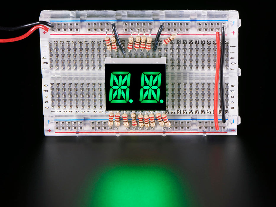 green Dual Alphanumeric Display module wired to breadboard, all segments lit