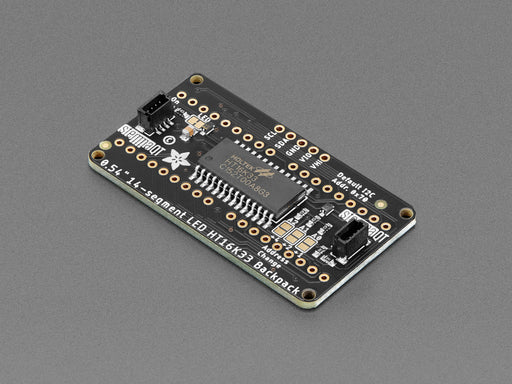 Overhead shot of an assembled 14-segment LED backpack, emitting the follow text in white LEDS: "AdaFruit 14-Segment Backpack"