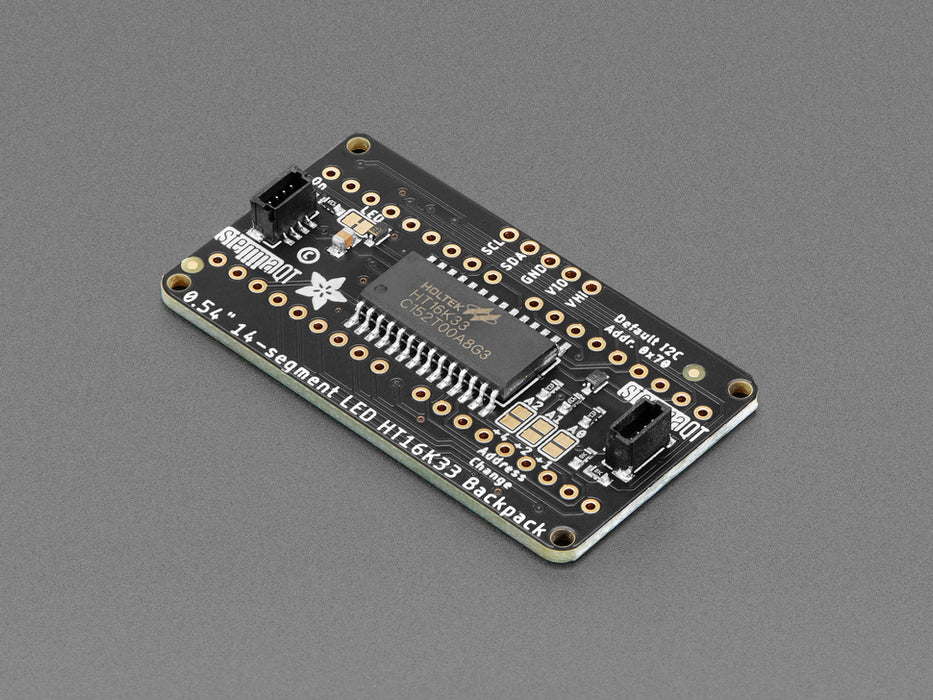 Overhead shot of an assembled 14-segment LED backpack, emitting the follow text in yellow LEDS: "AdaFruit 14-Segment Backpack"