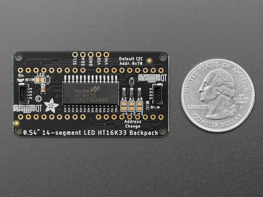 Overhead shot of an assembled 14-segment LED backpack, emitting the follow text in yellow LEDS: "AdaFruit 14-Segment Backpack"