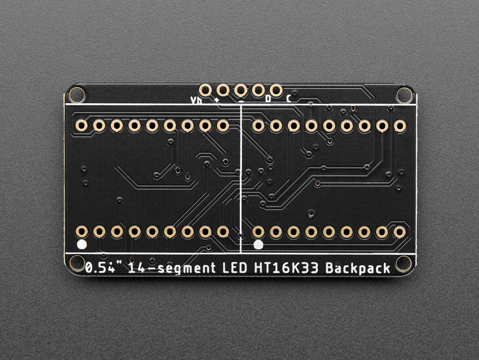 Overhead shot of an assembled 14-segment LED backpack, emitting the follow text in yellow LEDS: "AdaFruit 14-Segment Backpack"