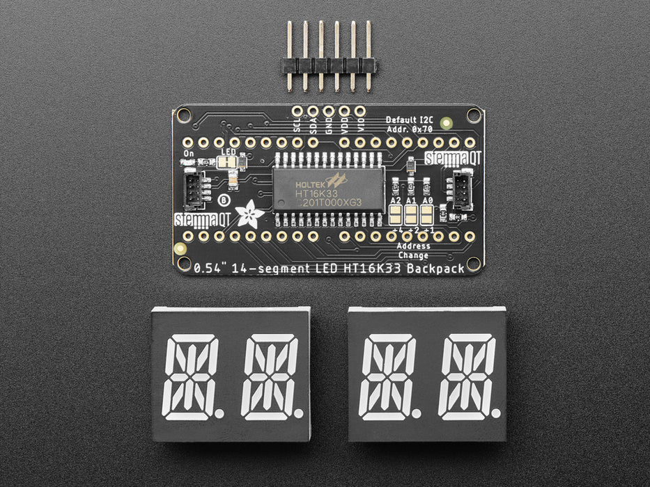 Overhead shot of an assembled 14-segment LED backpack, emitting the follow text in green LEDS: "AdaFruit 14-Segment Backpack"