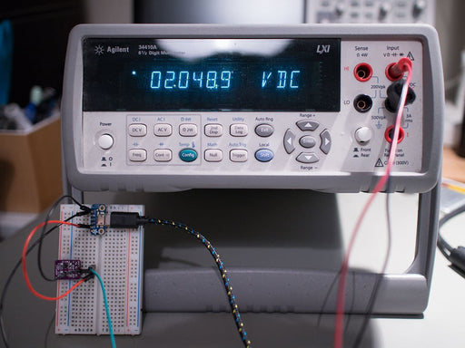 Angled shot of small, blue, rectangular voltage breakout board.