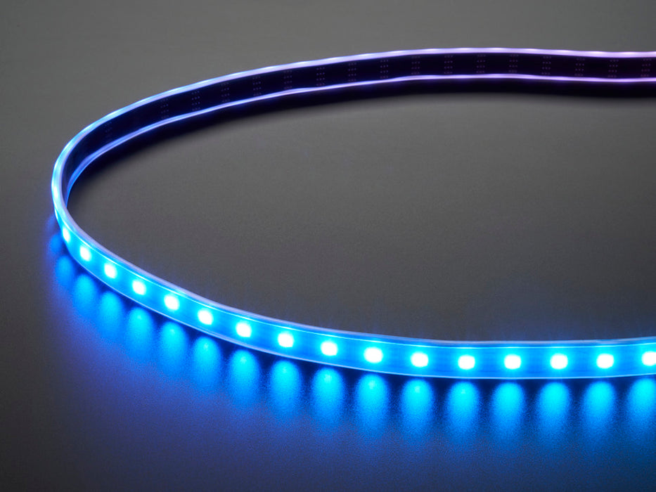 Part of a coiled LED strip glowing purple LEDs.