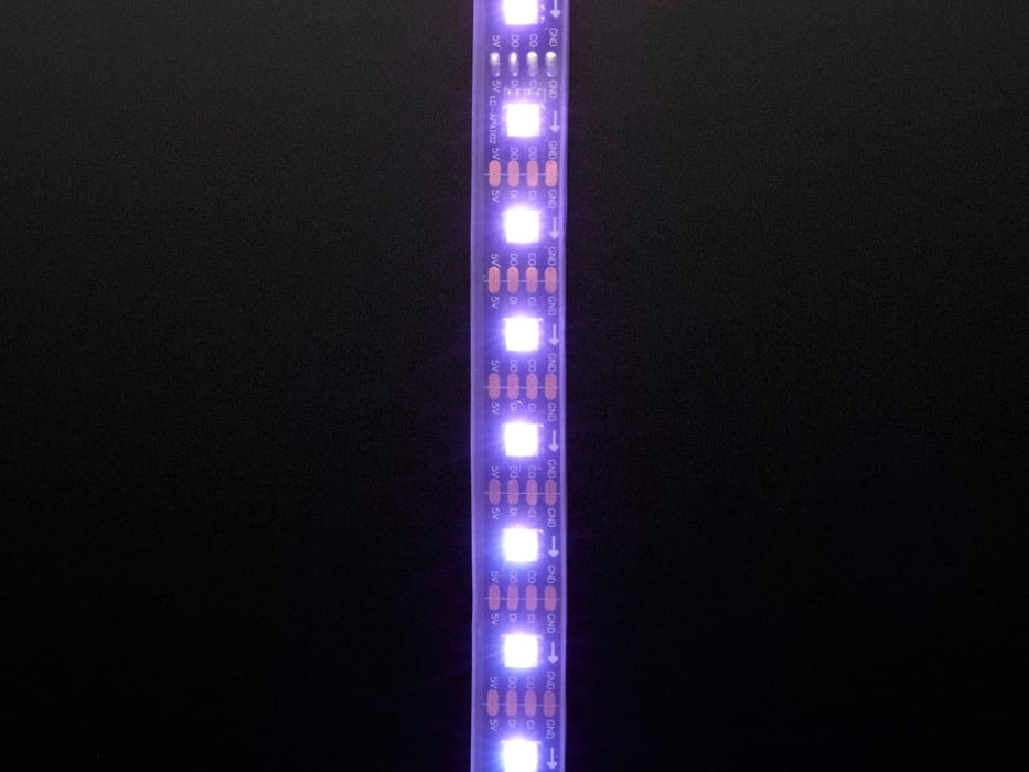 Part of a coiled LED strip glowing purple LEDs.