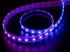 Video of part of a coiled LED strip glowing various colors in succession.