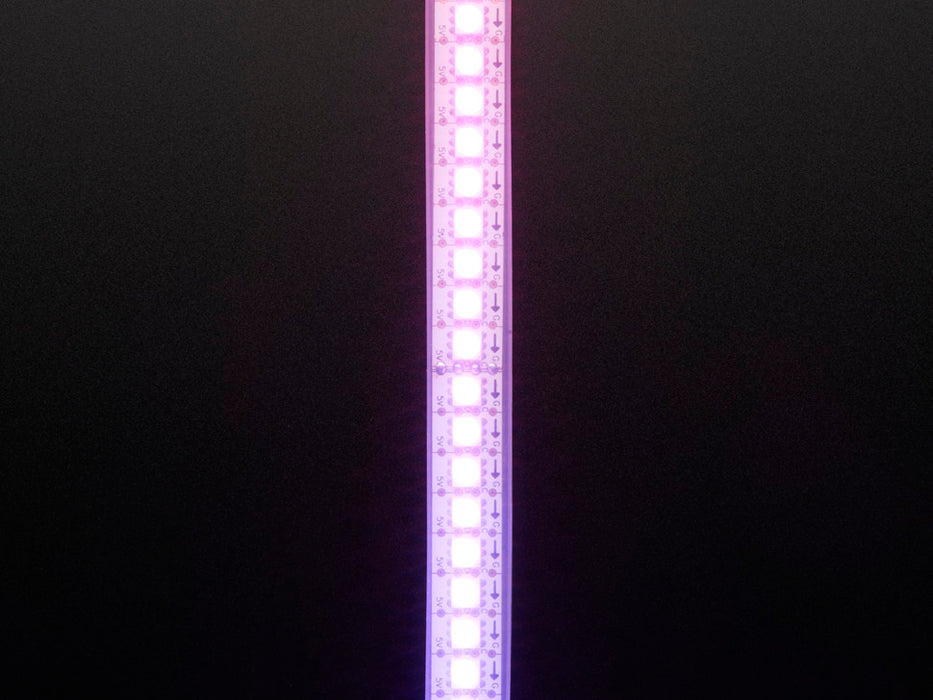 Shot of lightly coiled LED strip glowing rainbow colors.