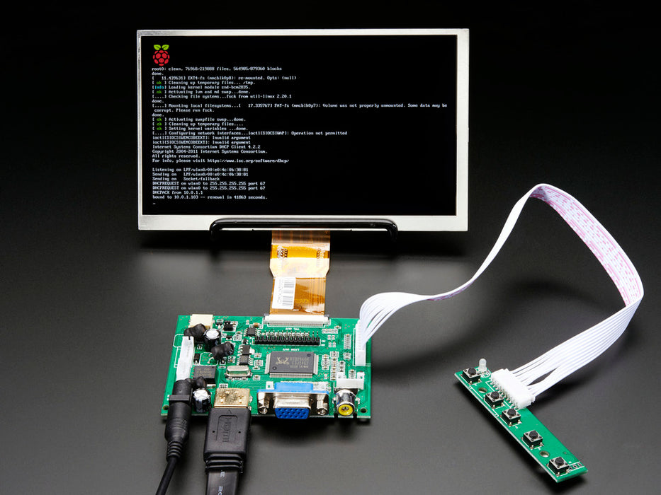 Front shot of a HDMI 4 Pi: 7" Display. The monitor displays a desktop background with a adafruit logo, raspberry logo, and a heart. 