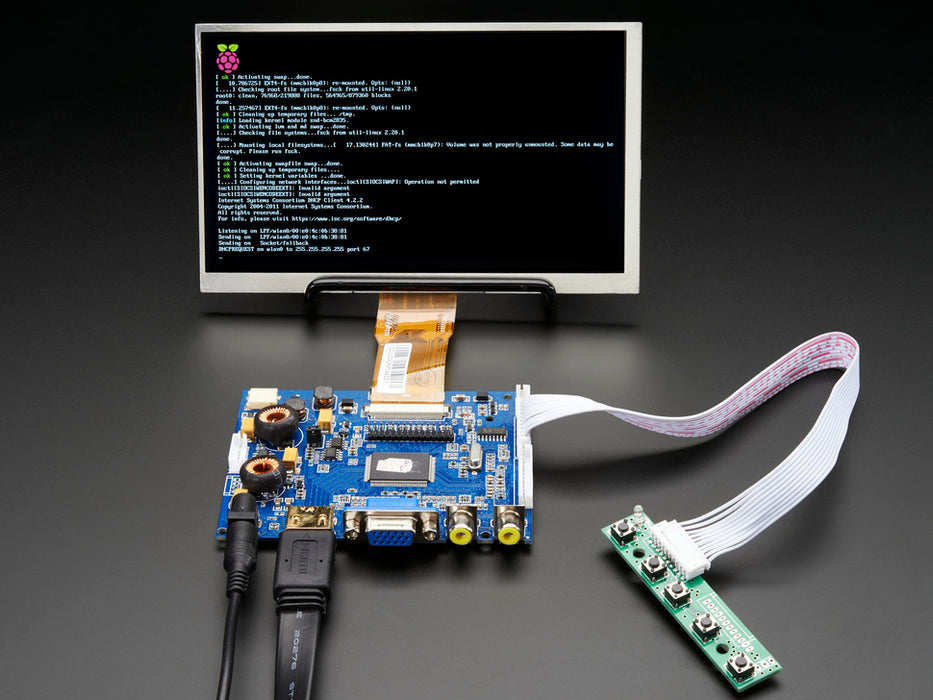 Front shot of a HDMI 4 Pi: 7" Display. The monitor displays a desktop background with a adafruit logo, raspberry logo, and a heart. 