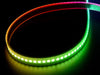 Shot of lightly coiled LED strip glowing rainbow colors.