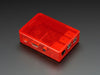 Assembled red acrylic Raspberry Pi case with no lid.