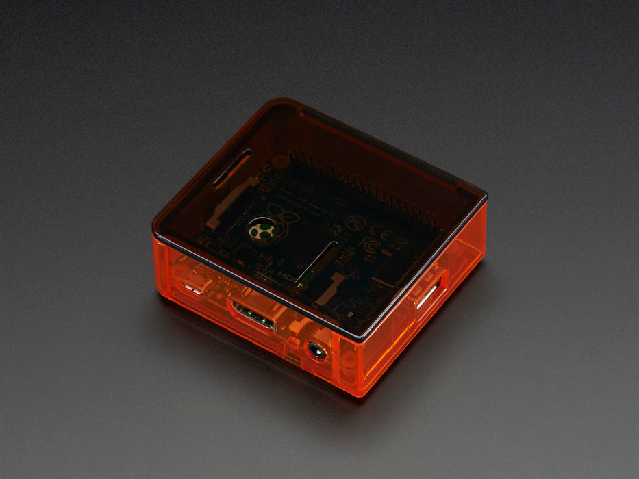 Angled shot of orange Raspberry Pi Model A+ Case without lid.