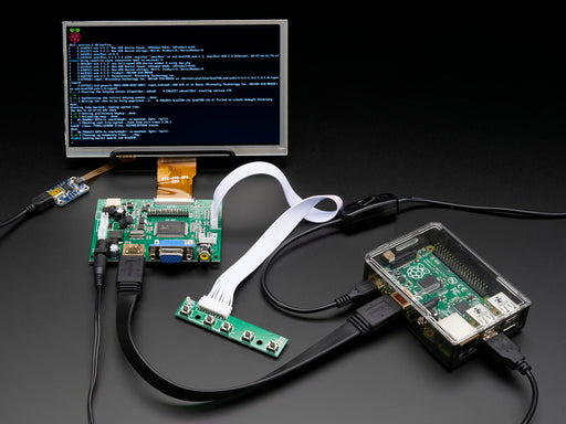 Front shot of a HDMI 4 Pi: 7" Display connected to a Raspberry Pi. The monitor displays a desktop background with a adafruit logo, raspberry logo, and a heart. 