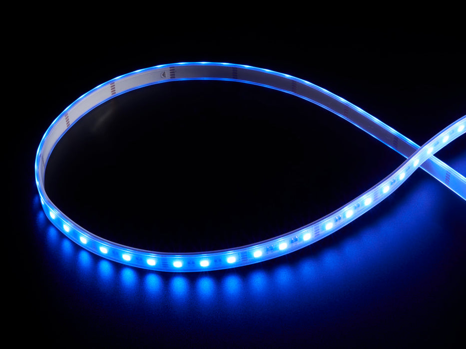 Coiled warm white LED strip with LEDs changing color throughout rainbow and also white