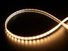 Coiled warm white LED strip with LEDs changing color throughout rainbow and also white