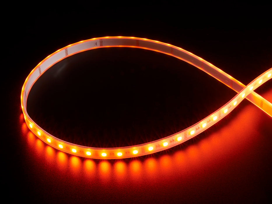 Coiled warm white LED strip with LEDs changing color throughout rainbow and also white