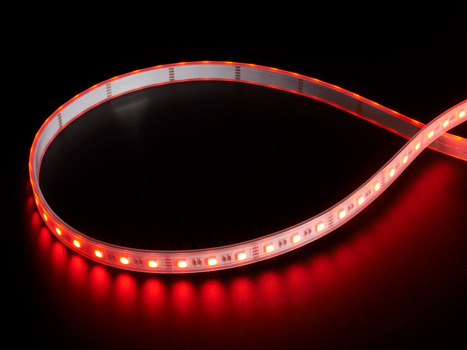 Coiled cool white LED strip with LEDs changing color throughout rainbow and also white