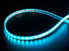 Coiled cool white LED strip with LEDs changing color throughout rainbow and also white