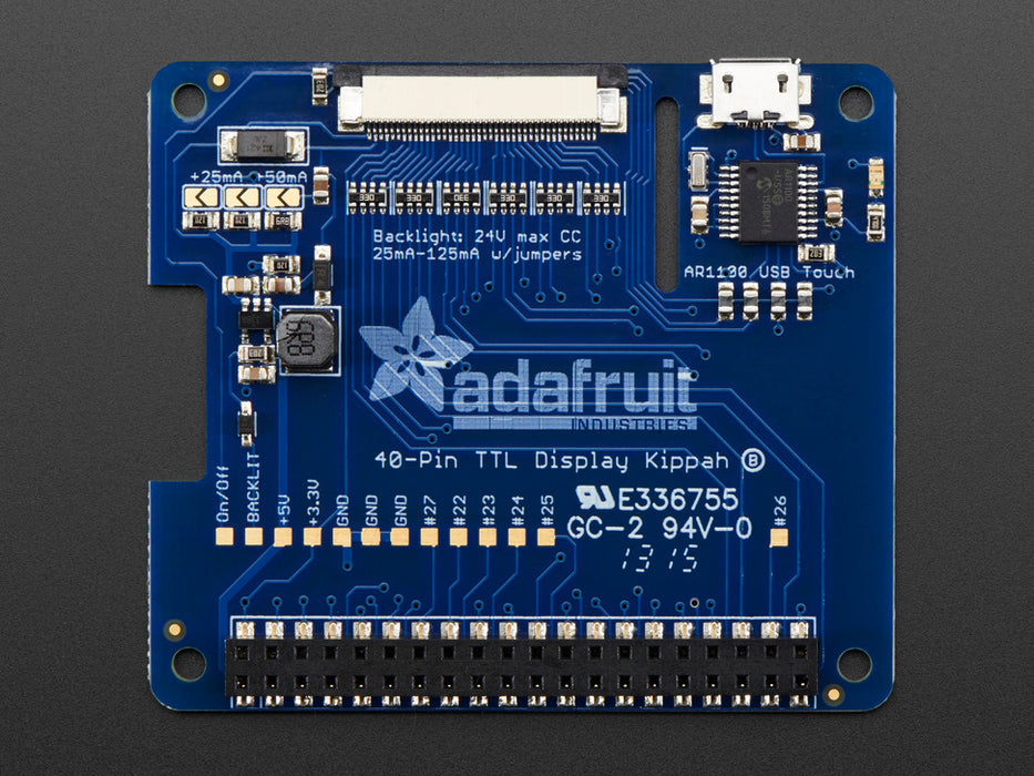 Front view of a white hand touching Adafruit DPI TFT Kippah for Raspberry Pi with Touch Support that connected to a Raspberry Pi