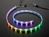 Adafruit NeoPixel Digital RGB LED Strip wired to a microcontroller, with all the LEDs in a rainbow