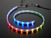 Adafruit NeoPixel Digital RGB LED Strip wired to a microcontroller, with all the LEDs in a rainbow