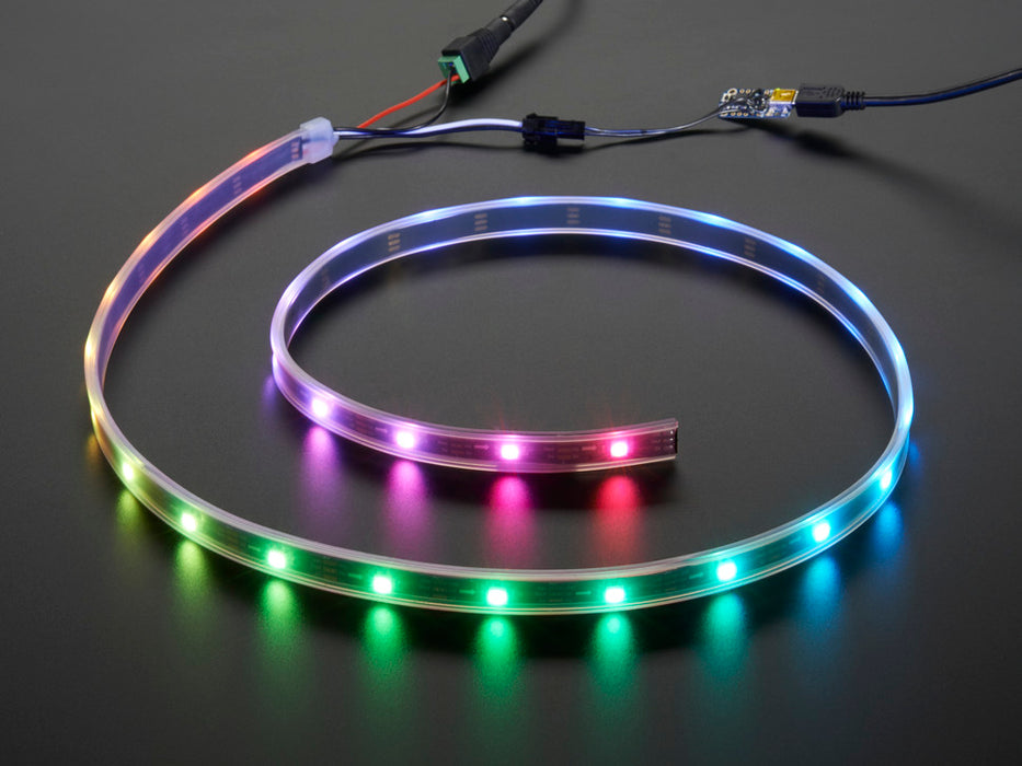 Adafruit NeoPixel Digital RGB LED Strip wired to a microcontroller, with all the LEDs in a rainbow