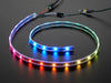 Adafruit NeoPixel Digital RGB LED Strip wired to a microcontroller, with all the LEDs in a rainbow