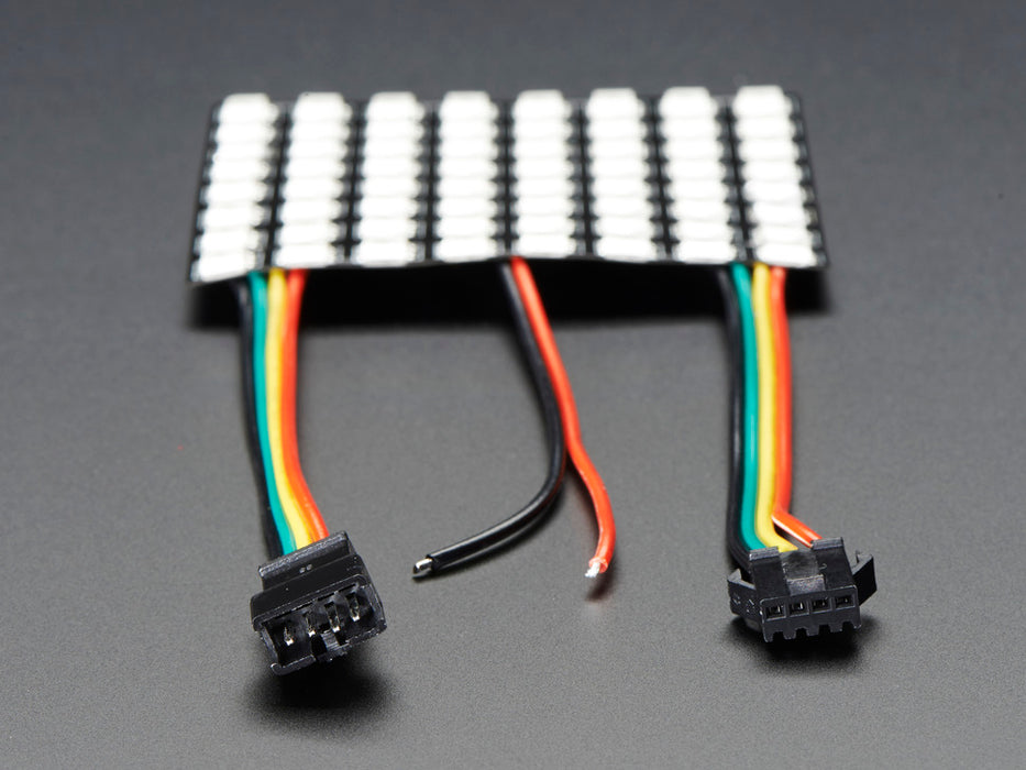 Two hands flexing a rainbow pulsing Flexible Adafruit DotStar Matrix 8x8 - 64 RGB LED Pixels.