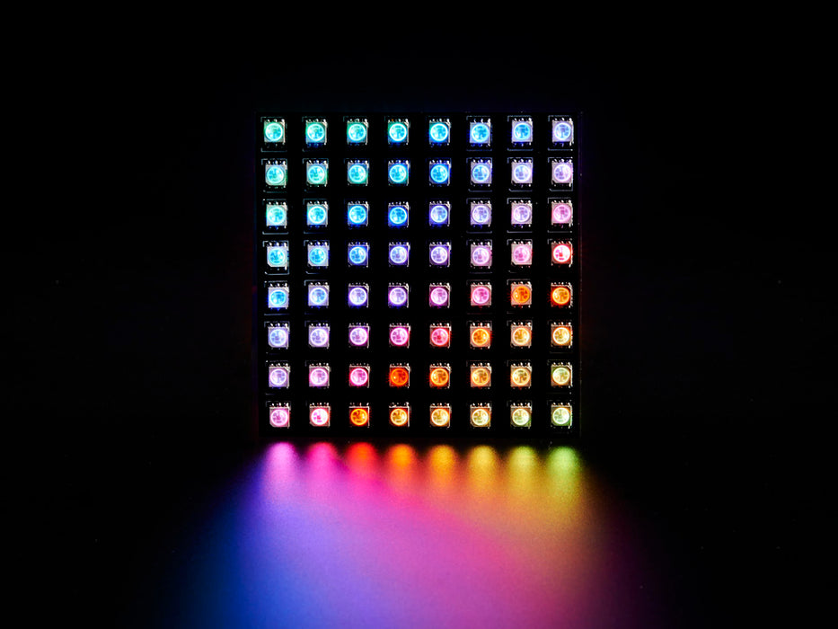 Two hands flexing a rainbow pulsing Flexible Adafruit DotStar Matrix 8x8 - 64 RGB LED Pixels.