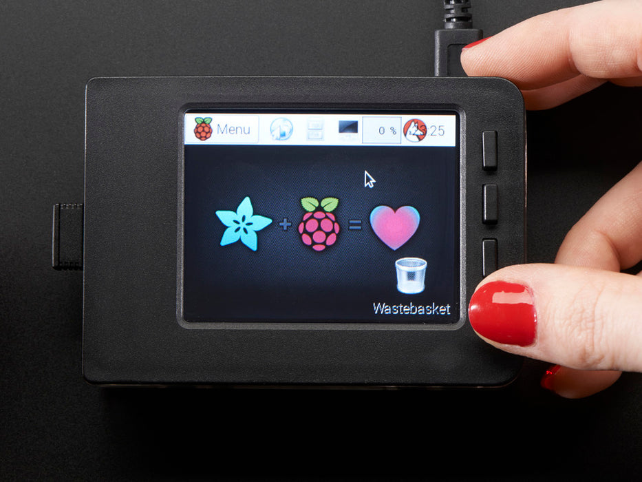 Red polished white hand holding a Faceplate and Buttons Pack placed on a Pi. 