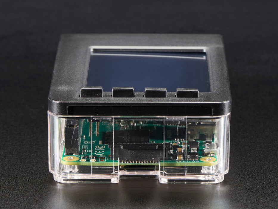 Red polished white hand holding a Faceplate and Buttons Pack placed on a Pi. 