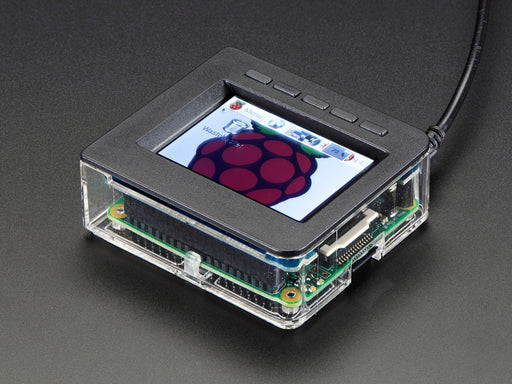 Top-down shot of assembled 2.4" PiTFT HAT. A red manicured finger presses a button above the display which shows a raspberry logo.