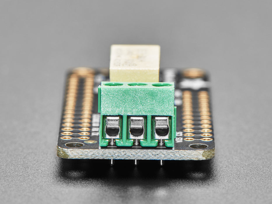 Angled shot of an Adafruit Non-Latching Mini Relay FeatherWing. 
