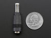 Top-down of 2.1mm to 2.5mm DC Barrel Plug Adapter next to US quarter for scale. 