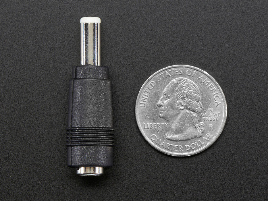 Top-down of 2.1mm to 2.5mm DC Barrel Plug Adapter next to US quarter for scale. 