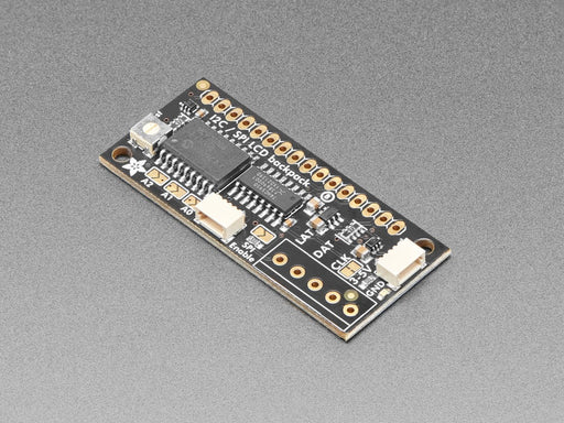 Overhead video demo of an LCD backpack wired to a small square microcontroller. Display on LCD reads: "adafruit (heart symbol) 16x2 character LCDs"