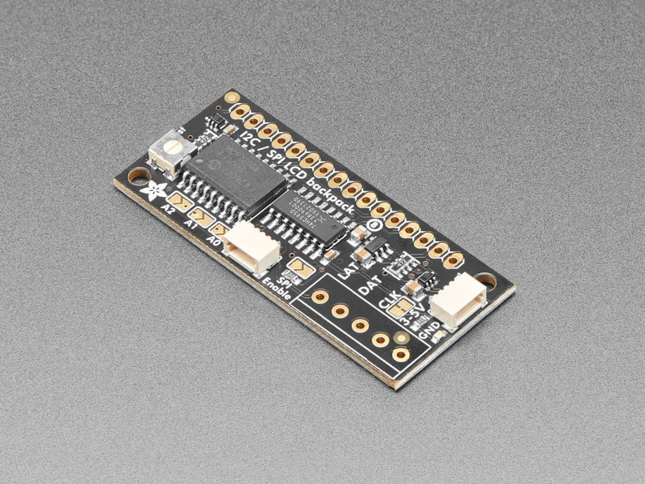 Overhead video demo of an LCD backpack wired to a small square microcontroller. Display on LCD reads: "adafruit (heart symbol) 16x2 character LCDs"