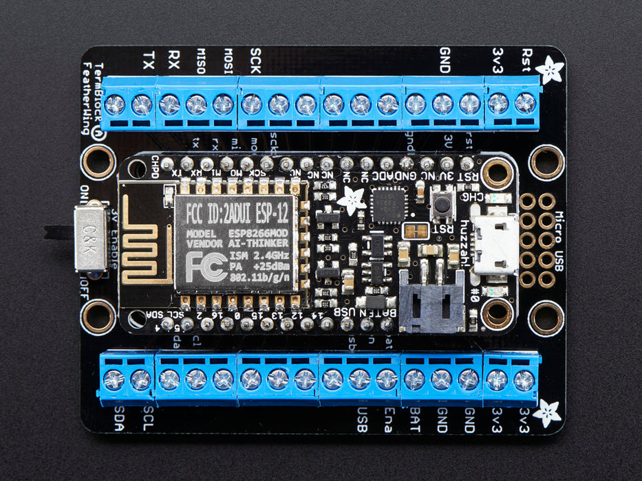 Angled shot of an Assembled Terminal Block Breakout FeatherWing for all Feathers with black headers. 