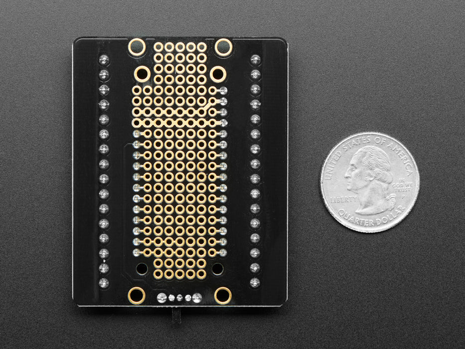 Angled shot of an Assembled Terminal Block Breakout FeatherWing for all Feathers with black headers. 