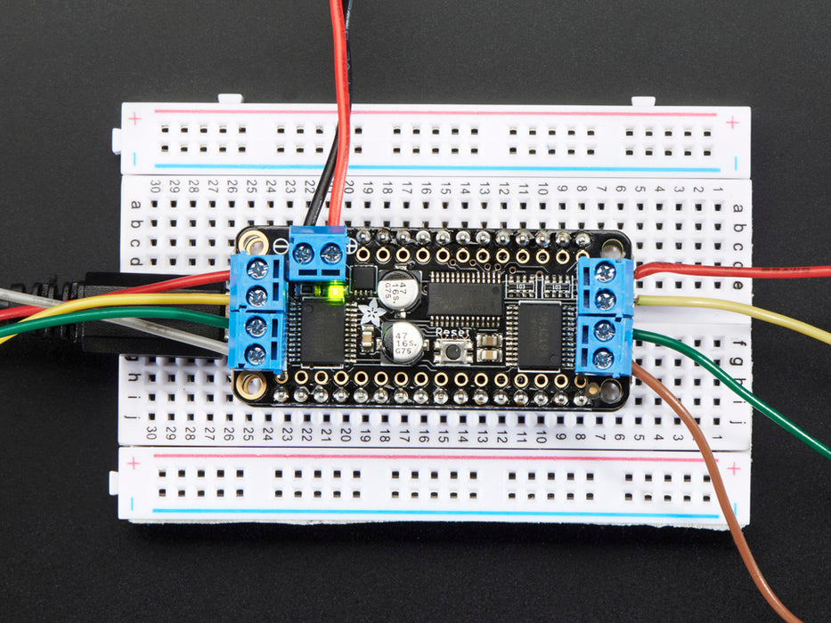 Video of 2 steppers spinning with rectangular black board on them powered by a DC Motor + Stepper FeatherWing Add-on For All Feather Boards