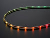 Adafruit NeoPixel Digital RGB LED Strip wired with all the LEDs illuminating various colors. 