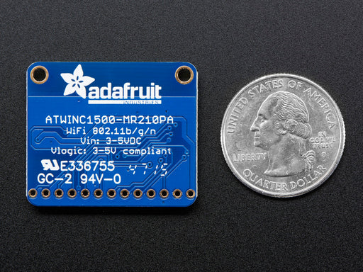 Angled shot of blue, square WiFi breakout board.